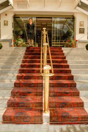 Leukerbad, Switzerland - 2 october 2002:  receptionist waiting for customers at entrence of a hotel at Leukerbad on the Swiss alpsのeditorial素材