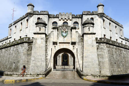 Havana, Cuba - 27 January 2016: Woman sitting in front of a fort at Old Havana on Cubaのeditorial素材