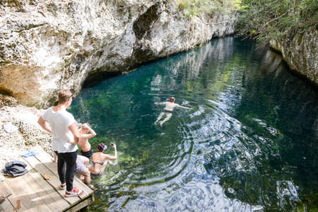 people swimming on a cenote at Giron on Cubaの写真素材
