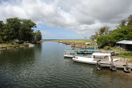Rocha, Uruguay - 12 February 2011: people waiting for customers at their boats on a river at Rocha on Urugauyのeditorial素材