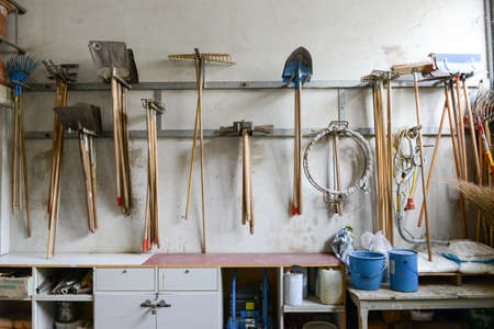 Gardening tools hanging on the wall
