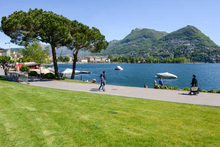 Lugano, Switzerland - 5 may 2016:  People walking on the lakeside of Lugano on the italian part of Switzerlandのeditorial素材