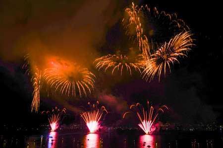 Brightly colorful fireworks in the night skyの写真素材