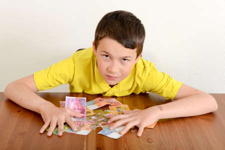 Child showing proudly his moneyの写真素材