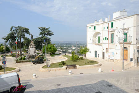 Cisternino, Italy - 25 June 2016: municipal gardeners at work in the main park of Cisternino on Puglia, Italyのeditorial素材