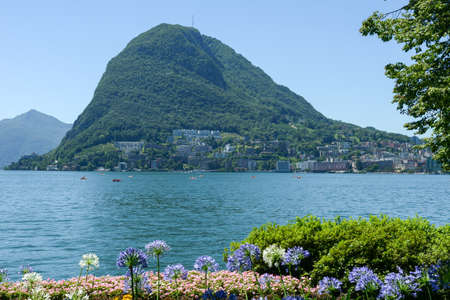 Lugano, Switzerland - View of the bay and mount Salvatore from the botanical garden of the cityの写真素材