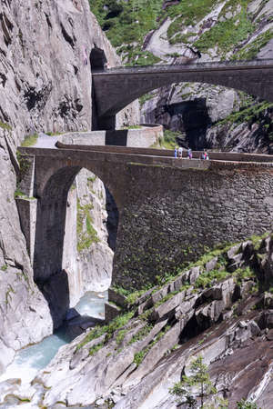 Andermatt, Switzerland - 7 august 2016: people walking on Devil's bridge at St. Gotthard pass on the Swiss alpsの写真素材