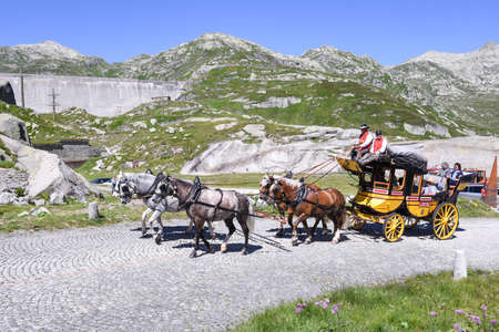 St. Gotthard pass, Switzerland - 7 august 2016: people driving a traditional horse carriage on the old road at St. Gotthard pass on the Swiss alpsのeditorial素材