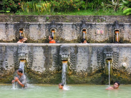 Banjar (Bali), Indonesia - 8 february 2013: People under the water jets of the public pool at Banjar on the island of Bali, Indonesiaのeditorial素材