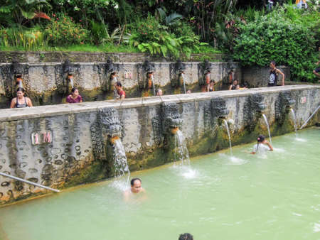Banjar (Bali), Indonesia - 8 february 2013: People under the water jets of the public pool at Banjar on the island of Bali, Indonesiaのeditorial素材