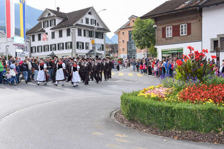 Kerns, Switzerland - 1 October 2016: People wearing traditional clothes and singing in a parade at Kerns on the Swiss alpsのeditorial素材