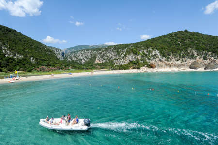Cala Luna, Italy - 28 June 2013: a boat cruising in front of Cala Luna beach in Orosei bay on Sardinia, Italy.のeditorial素材
