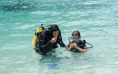 Cala Mariolu, Italy - 28 June 2013: Child discover scuba diving at Cala Mariolu beach on Sardinia, Italyのeditorial素材