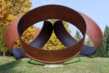 Art object in front of autumn trees on the wood of Carona on Switzerlandのeditorial素材