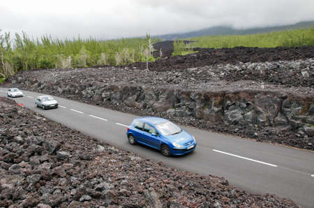 La Reunion island, France - 29 December 2002: people driving them car on the road at the place of the last lava eruption on La Reunion island, Franceのeditorial素材