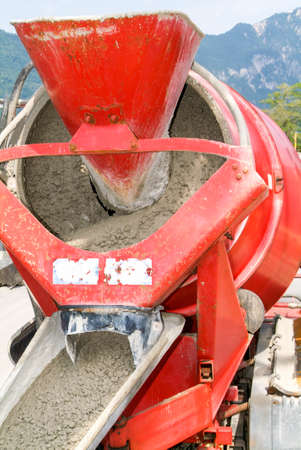 Bissone, Switzerland - 22 May 2009: Truck operator pouring cement into crane bucket with a cement truck mixerのeditorial素材