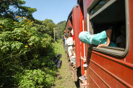 Kandy, Sri Lanka - 20 December 2004:  people who look out of the windows of the train that is carrying them to Kandy on Sri Lankaのeditorial素材