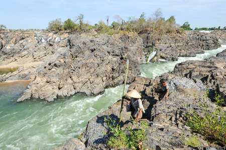 Don Khon, Laos - 25 January 2012: woman and boy walking near the Mekong river at Don Khon island on Laosのeditorial素材