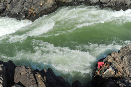 Don Khon, Laos - 25 January 2012: people fishing with a rudimentary network in the Mekong river at Don Khon island on Laosのeditorial素材