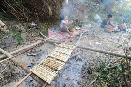 Don Khon island, Laos - 28 january 2012: Small fishs smoked on fire at Don Khon island on Laosのeditorial素材