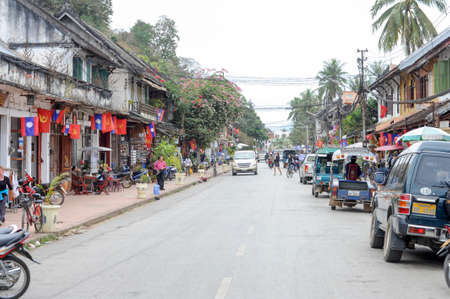 Luang Prabang, Laos - 12 January 2012: people walking on the streets with colonial houses of Luang Prabang on Laosのeditorial素材