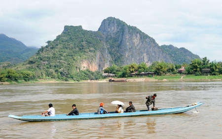 Luang Prabang , Laos -  13 January 2012: people cruising on a boat in river Mekong near Luang Prabang, Laosのeditorial素材