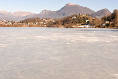 Frozen lake of Muzzano near Lugano on the italian part of Switzerlandの写真素材
