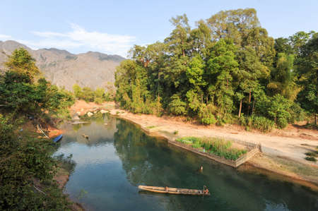 Ban Kong Lo, Laos - 20 january 2012: man traveling in a canoe on the river that leads to the Tham Kong Lo cave, Laosのeditorial素材