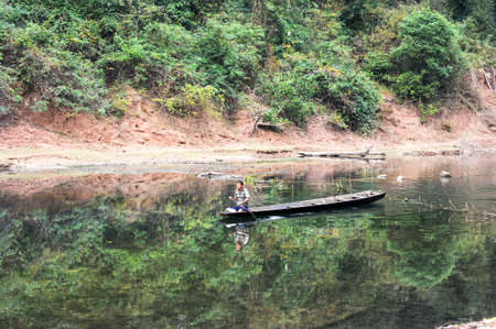 Ban Kong Lo, Laos - 20 january 2012: man traveling in a canoe on the river that leads to the Tham Kong Lo cave, Laosのeditorial素材