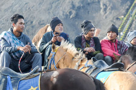 Bromo, Indonesia - 4 february 2013: horse riders smoking cigarettes on Mt.Bromo national park, Indonesiaのeditorial素材