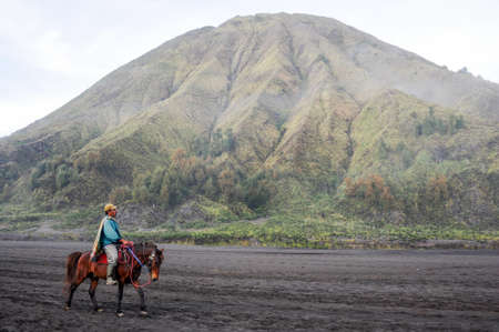 Bromo, Indonesia - 4 february 2013: horse rider on Mt.Bromo national park, Indonesiaのeditorial素材