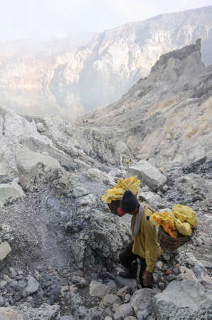 Vulcano Ijen, Indonesia - 5 February 2013: Miners with their sulfur crops climb the ijen crater on the island of Java, Indonesiaのeditorial素材