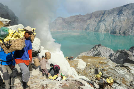 Vulcano Ijen, Indonesia - 5 February 2013: Miners with their sulfur crops climb the ijen crater on the island of Java, Indonesiaのeditorial素材