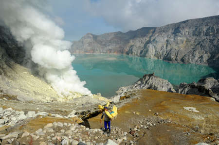 Vulcano Ijen, Indonesia - 5 February 2013: Miners with their sulfur crops climb the ijen crater on the island of Java, Indonesiaのeditorial素材