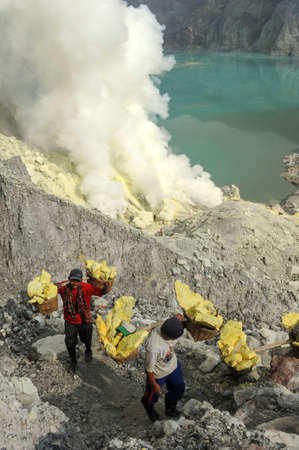 Vulcano Ijen, Indonesia - 5 February 2013: Miners with their sulfur crops climb the ijen crater on the island of Java, Indonesiaのeditorial素材