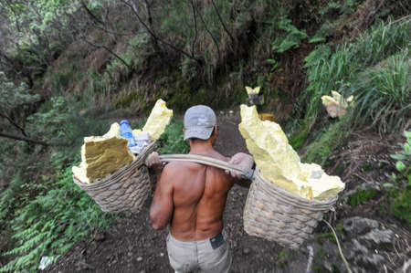 Vulcano Ijen, Indonesia - 5 February 2013: Miner with their sulfur crops from the ijen crater on the island of Java, Indonesiaのeditorial素材