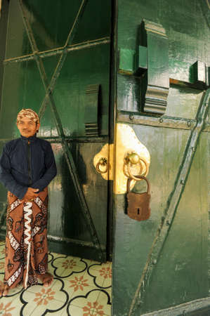 Yogyakarta, Indonesia - 28 January 2013: man standing in front of the entrance door of Kraton Palace at Yogyakarta, Indonesiaのeditorial素材