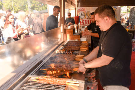 Lugano, Switzerland - April 29, 2017: Cook preparing grilled meat skewers at street food festival of Lugano on Switzerlandのeditorial素材