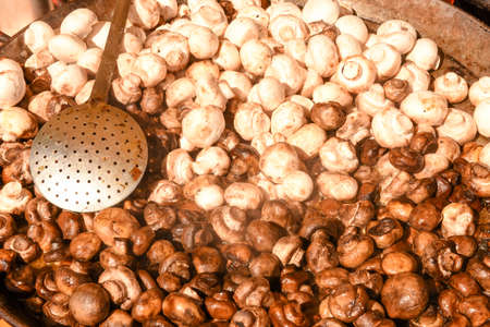 Fresh raw mushrooms in a iron pan at a street food marketの写真素材