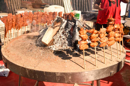 Grilled meat skewers cooked on the fire at street food festival of Lugano on Switzerlandの写真素材