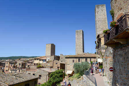 San Gimignano, Italy - 6 July 2017: people walking on the streets of San Gimignano on Italyのeditorial素材