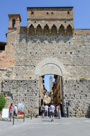 San Gimignano, Italy - 6 July 2017: people walking in front of the entrance gate at San Gimignano on Italyのeditorial素材