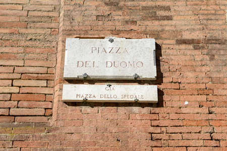 Street sign of Duomo square at Siena on Italyの写真素材