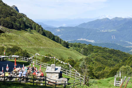 Pairolo, Switzerland - 15 July 2017:  People eating and drinking in the terrace of mountain house at Pairolo over Lugano on the italian part of Switzerlandのeditorial素材