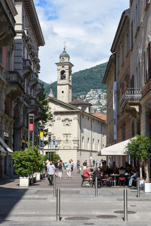 Lugano, Switzerland - 1 July 2017: people walking in front of St Rocco church in the city center of luxurious resort Lugano on Switzerlandのeditorial素材