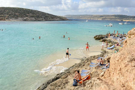 Comino, Malta - 30 October 2017: people swimming and sunbathing at Blue Lagoon on Comino in Maltaのeditorial素材