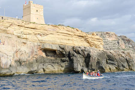 Blue Grotto, Malta - 3 November 2017: tourists visiting the coast by boat at Blue Grotto in the Malta islandのeditorial素材