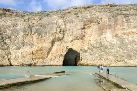 Gozo island, Malta - 30 October 2017: people walking on the pier of inland sea at Gozo Island, Malta.のeditorial素材