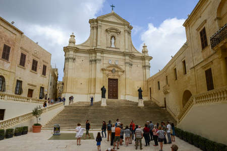 Victoria, Malta - 30 October 2017: people walking in front of the church at Victoria on Gozo island, Maltaのeditorial素材