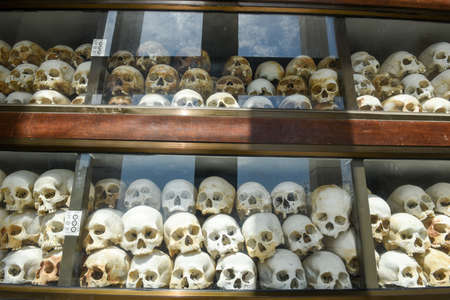 The skulls of torture victims resting in a stupa at the Killing Fields outside of Phnom Penh, Cambodia.のeditorial素材